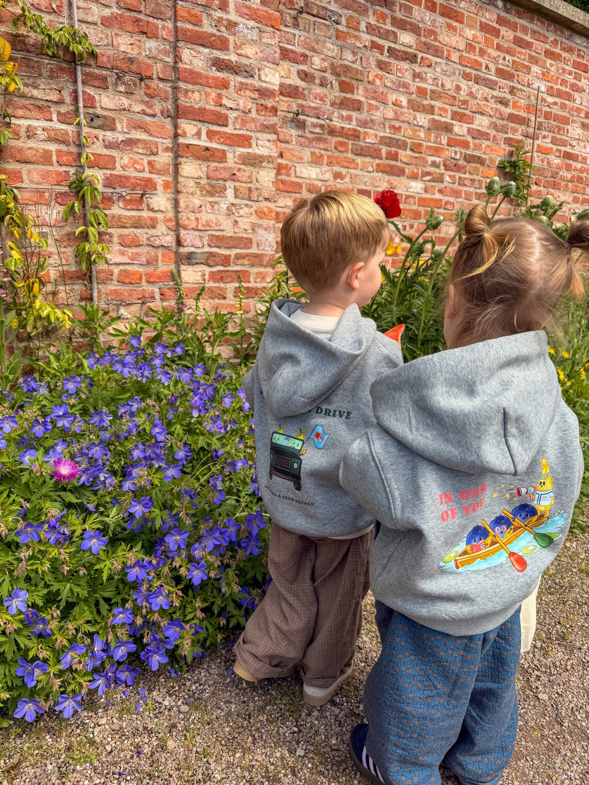 Two little ones in matching Patrick and Patricia hoodies in the garden